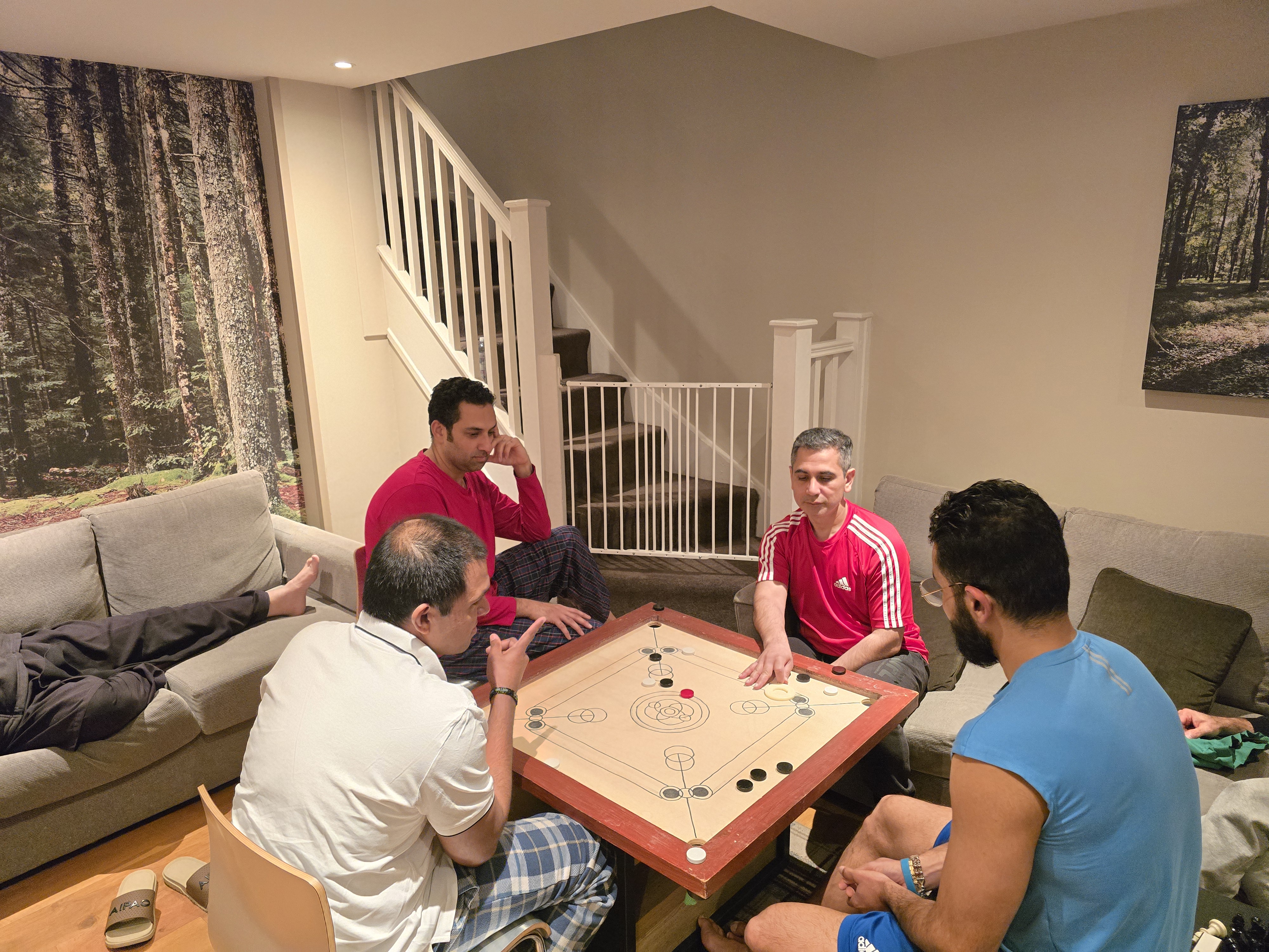 Intense Carrom games with giant striker